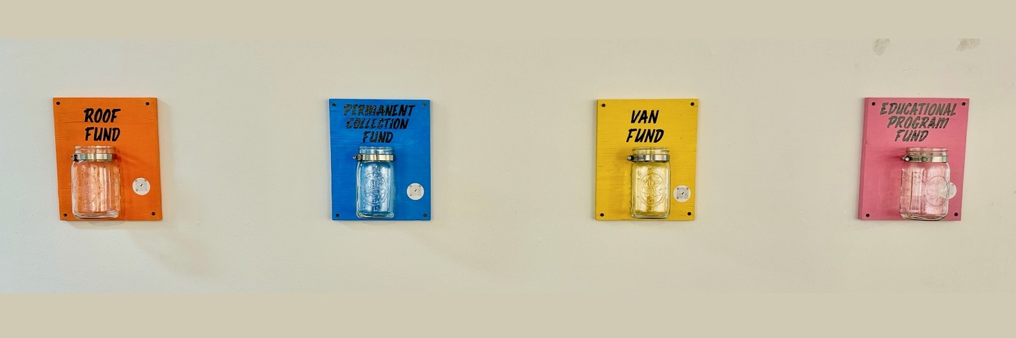Fundraising jars for the Roof Fund, the Permanent Collection Fund, the Van Fund, and the Educational Programming Fund